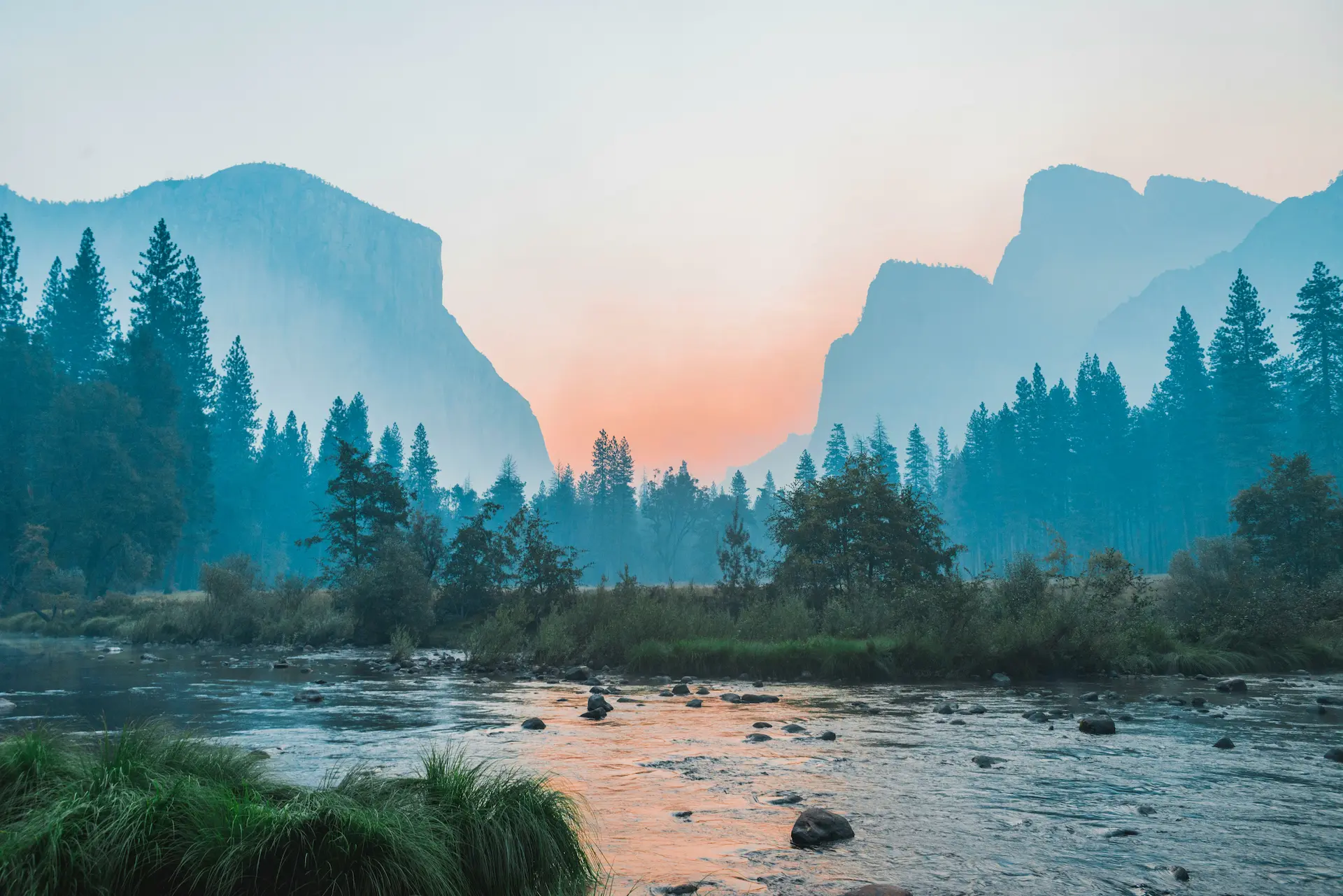 Yosemite valley with river in foreground and mountains in background